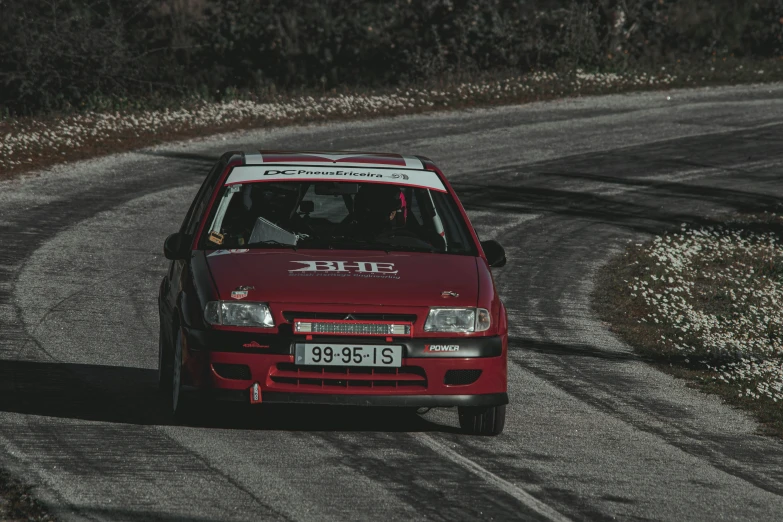 a red truck driving down a curved road