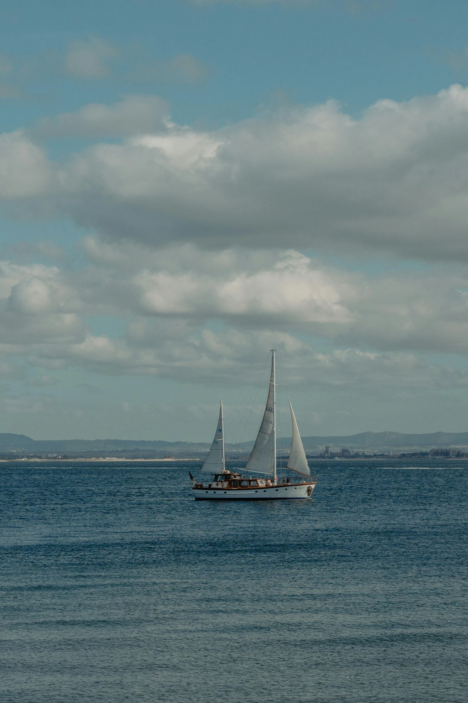 a sail boat on a body of water