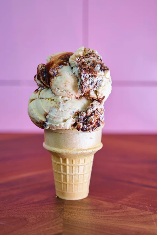 a ice cream cone sitting on top of a wooden table