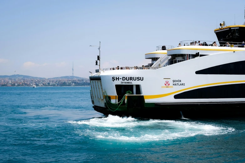 a large white and black ferry boat in the water