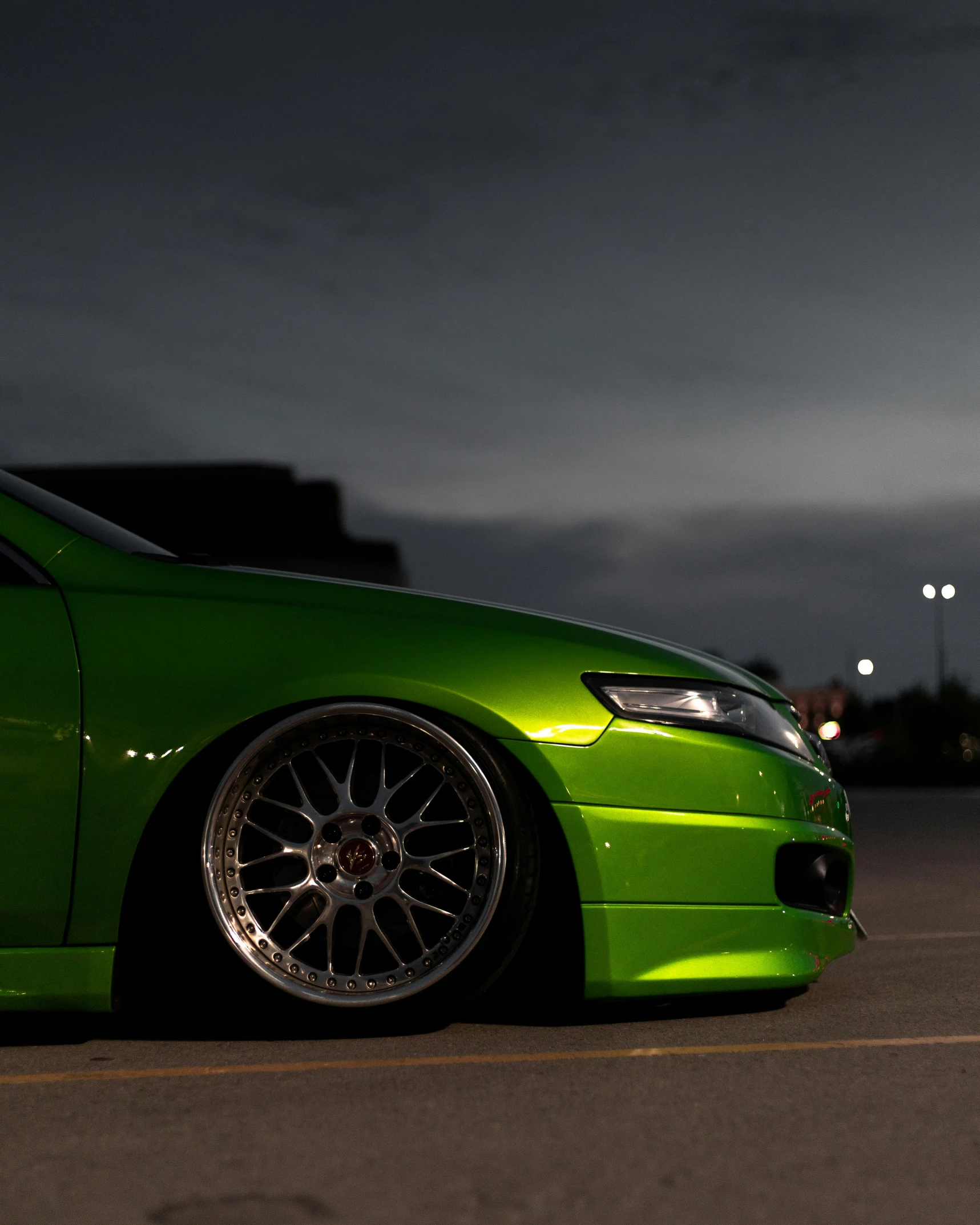 a car with some nice chrome wheels on a street