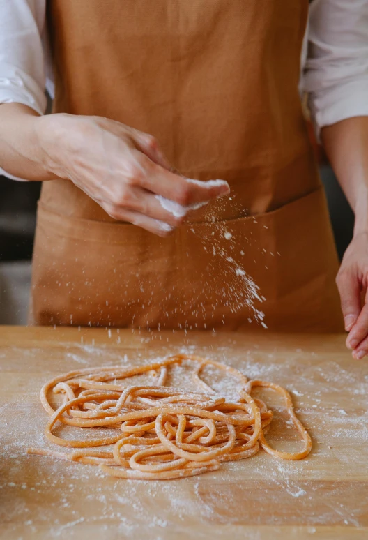 an image of a pasta cooking process being sprinkled