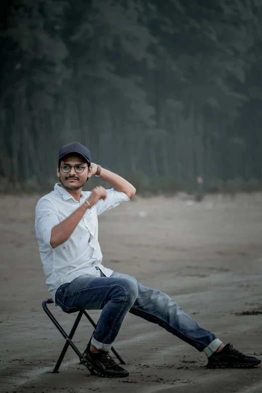 a man sitting in a chair on the beach