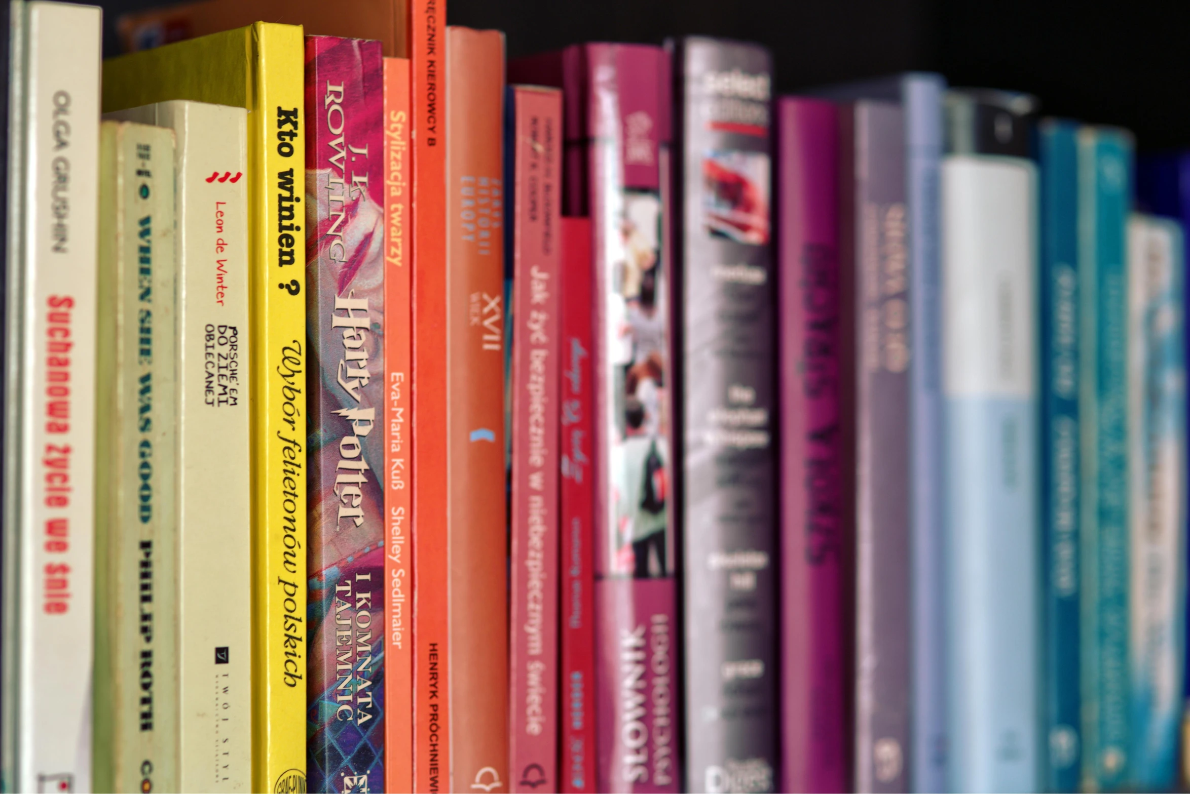 a row of books sitting on top of a shelf