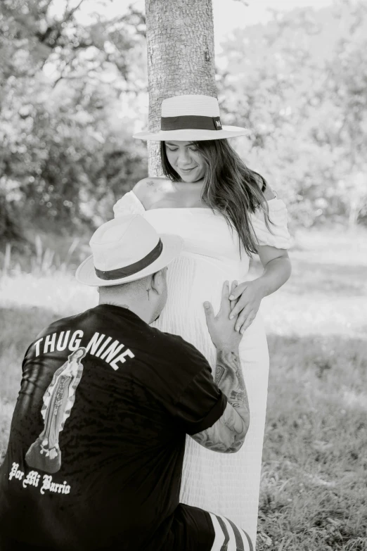 a man kneeling down to a woman who is hugging her