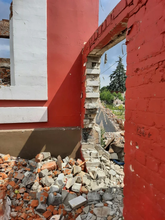 a red building sitting next to an unfinished window