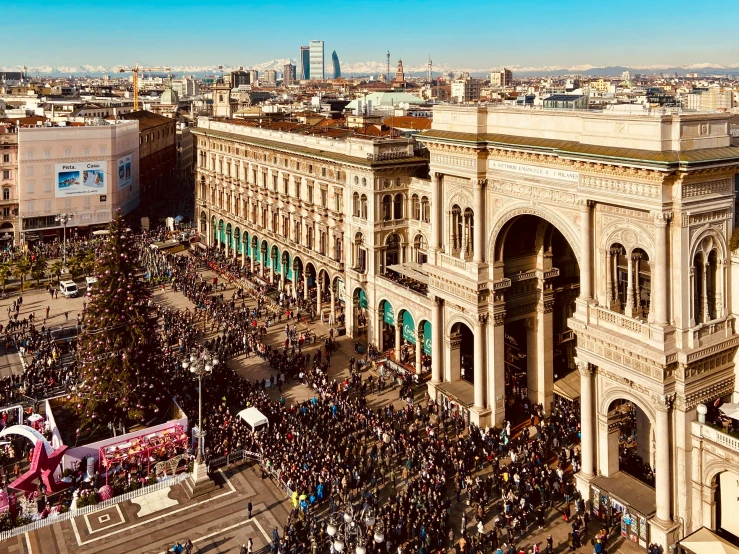 an aerial view of a city street with crowds in front