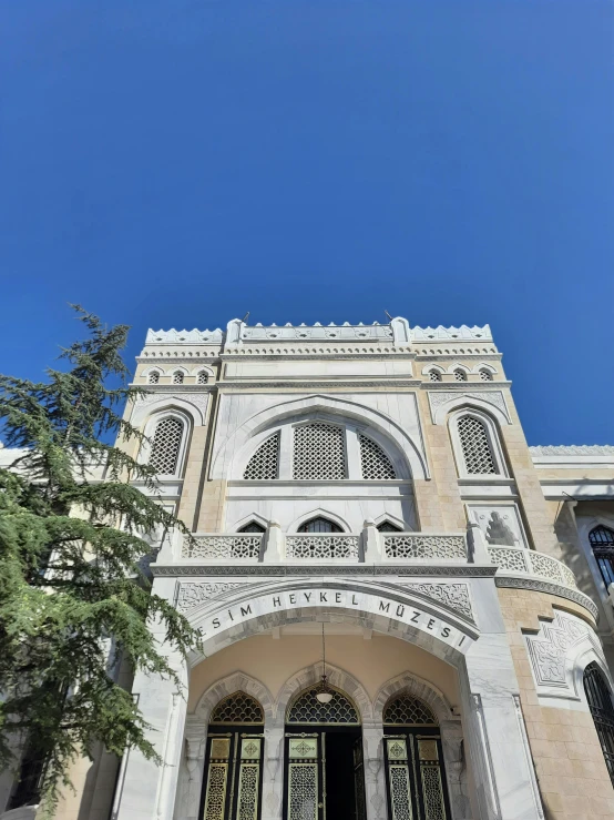 an outside view of a large building with a clock and ornate designs