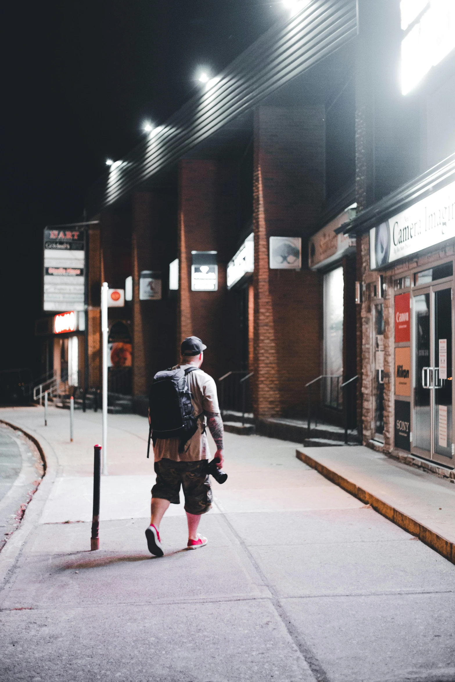 a man with a backpack walking down the street