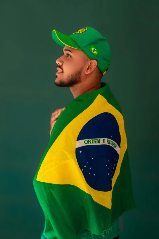 a man with a green cap standing and holding a flag
