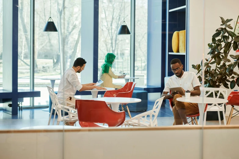 a man and woman sitting at a table in a cafe