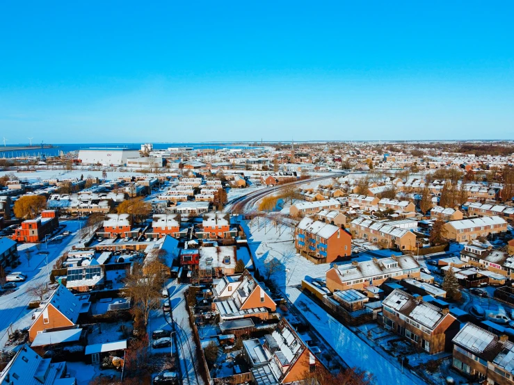 an aerial view of houses covered in snow