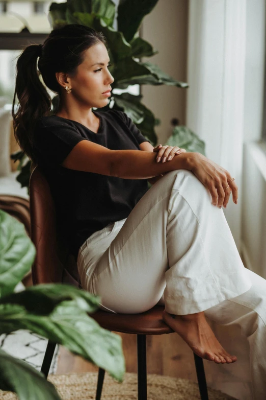 a woman sitting on a chair in a room