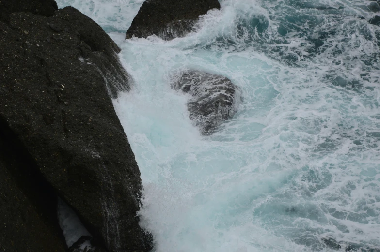 there is a rock with the water around it