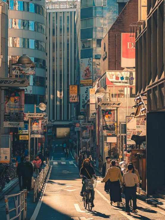 people walking and biking in the middle of the city