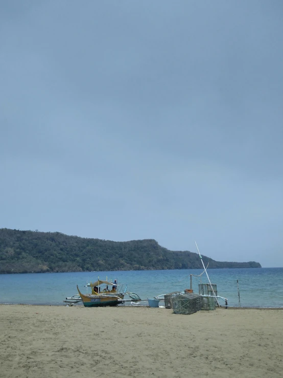 three boats that are sitting in the sand