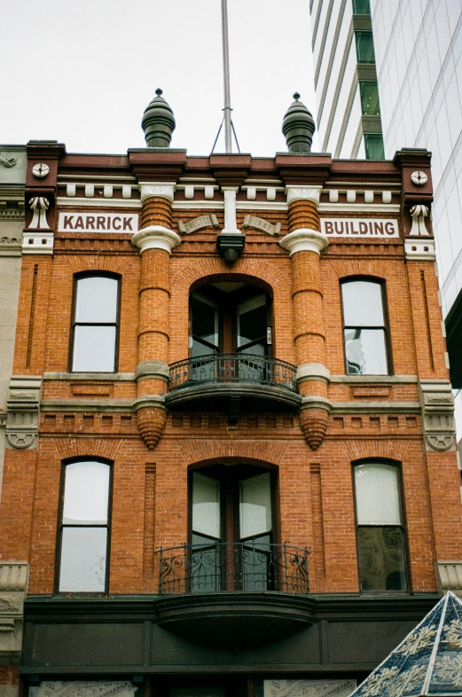 a building with a black iron balcony balconies