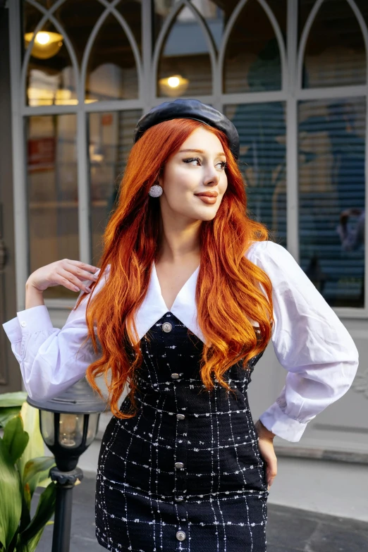 a redhead haired woman in a short dress with long red hair