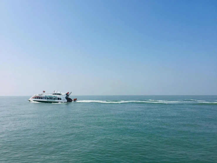 a boat is riding in the water with two men on it