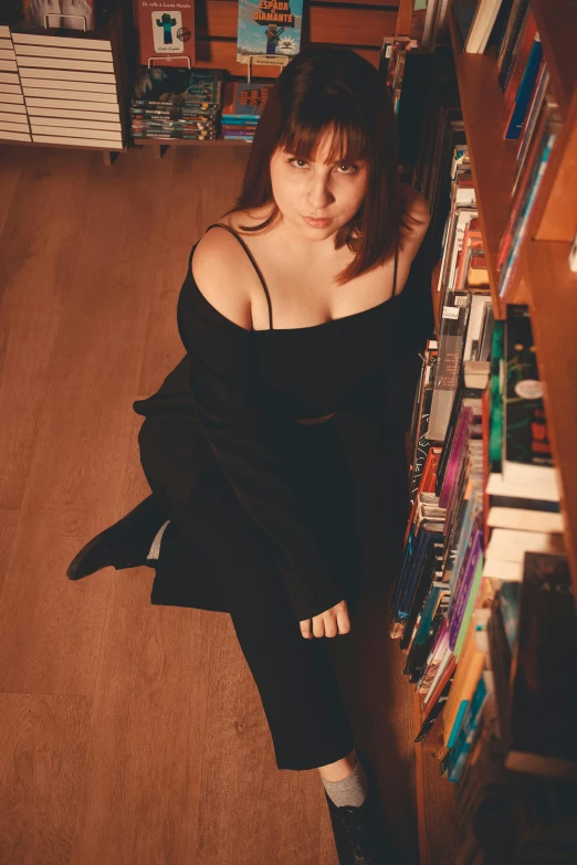 woman sitting in liry looking at books