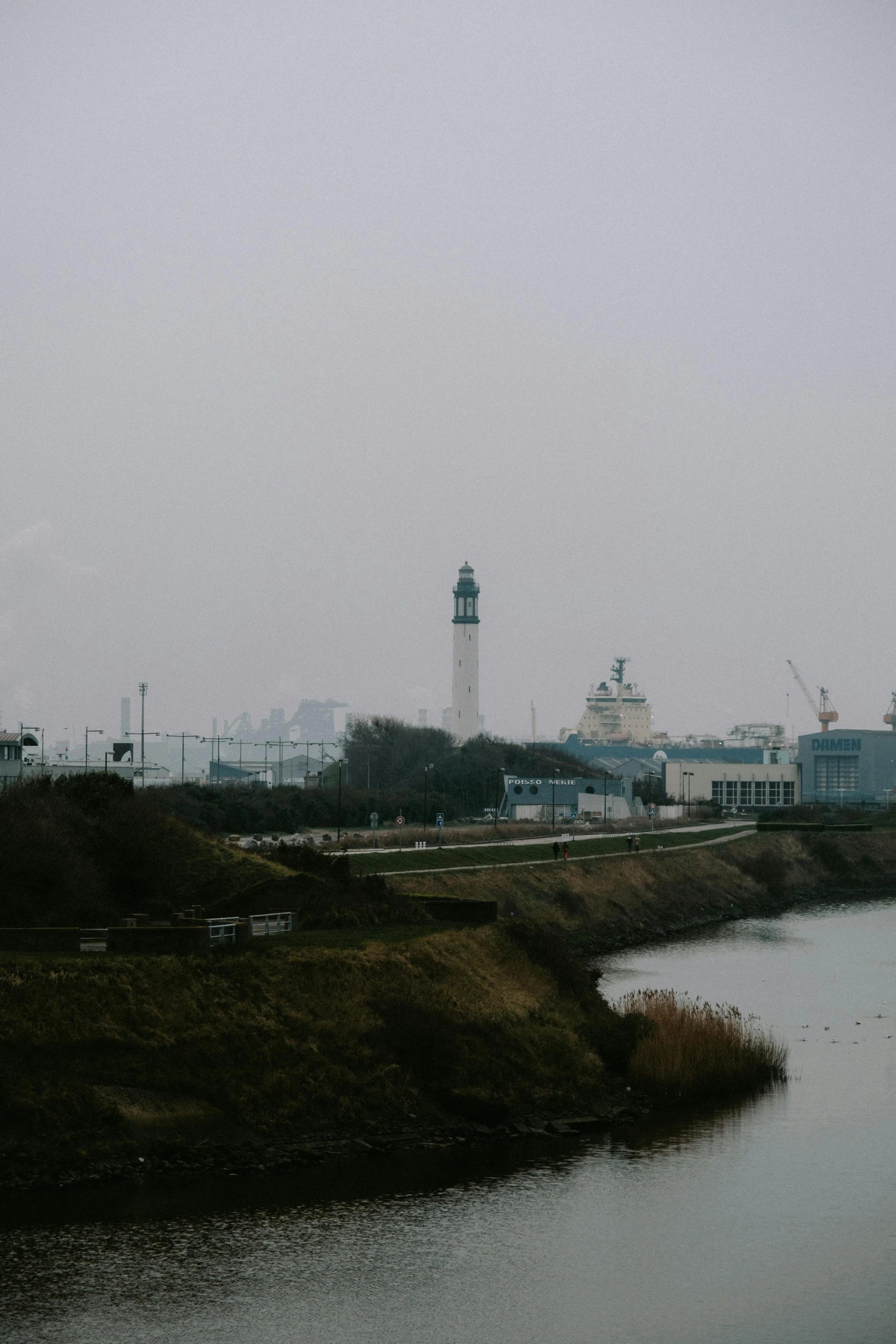 a body of water with a clock tower in the distance