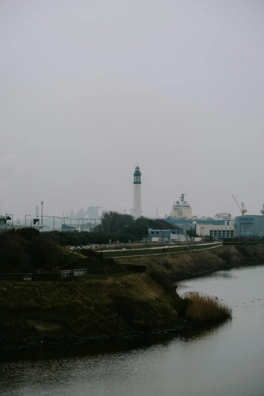 a body of water with a clock tower in the distance