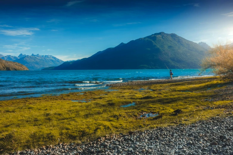 a small body of water near a large mountain range