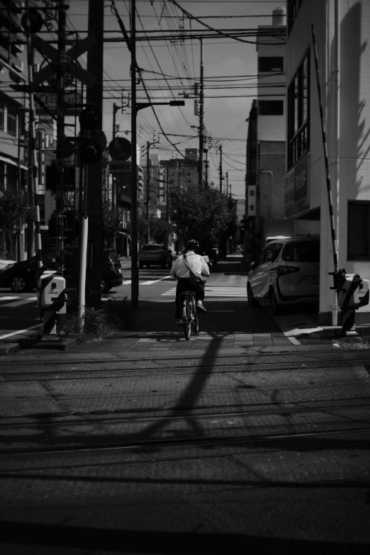 a person riding a bike in the middle of a city