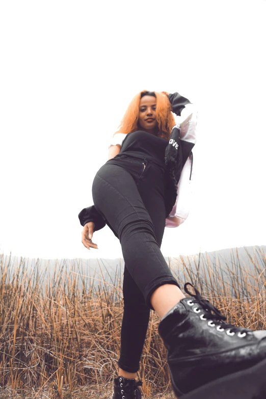 a woman with long hair in black and white outfit