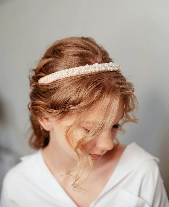 a woman with red hair wearing a headband