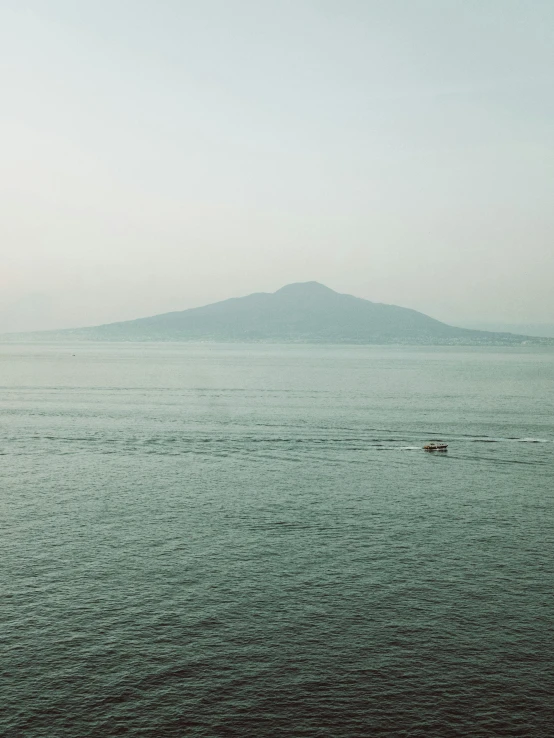 the large body of water is empty and a boat is in the distance