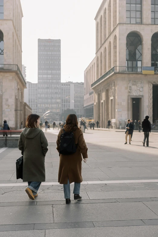 two women walking through an open air space