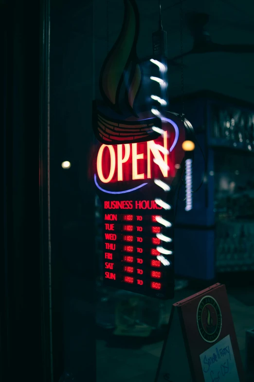 a neon open sign and a sign board inside