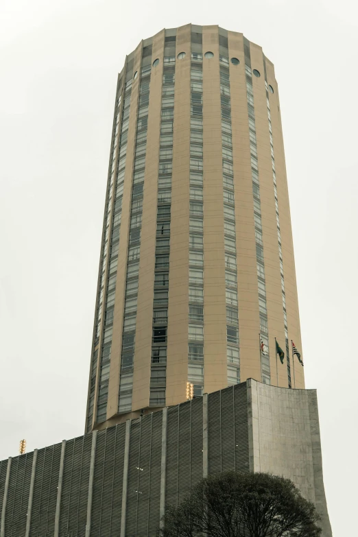 the top of a building with windows at the bottom and a tall metal structure near by