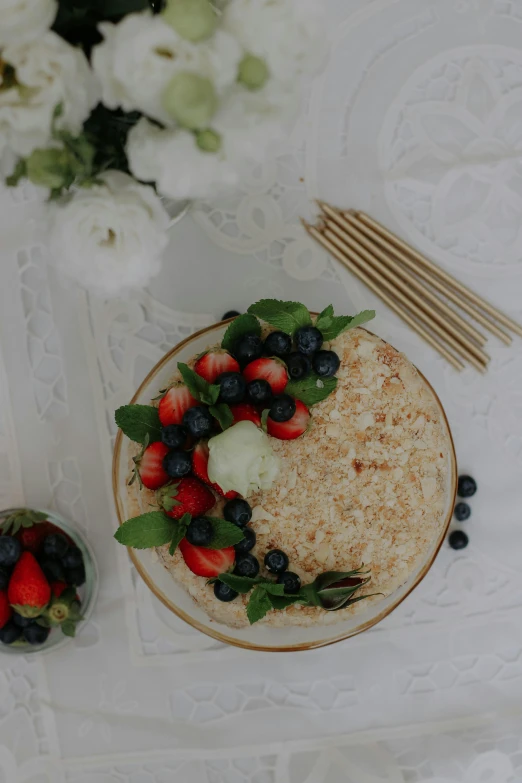 a plate with berries and an orange on it