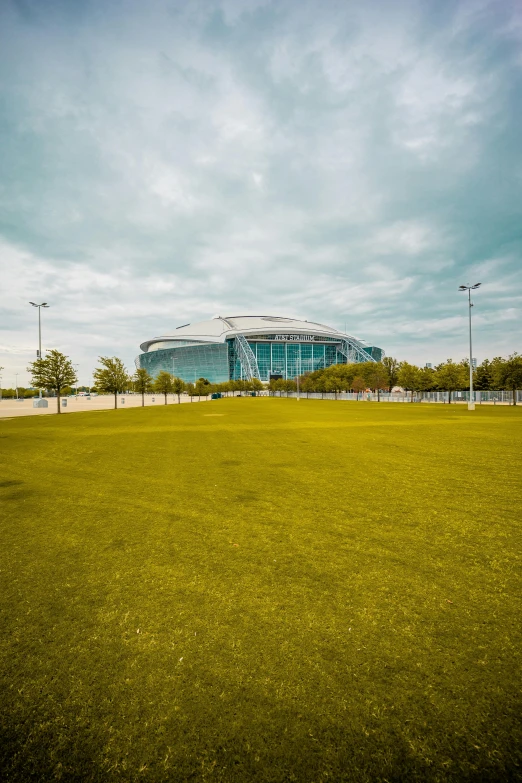 a view of a large building through the grass