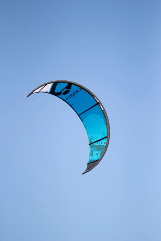 a large kite flying in the air under a blue sky