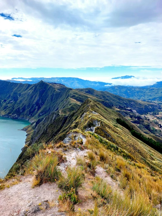 view of mountain lake from top of hill