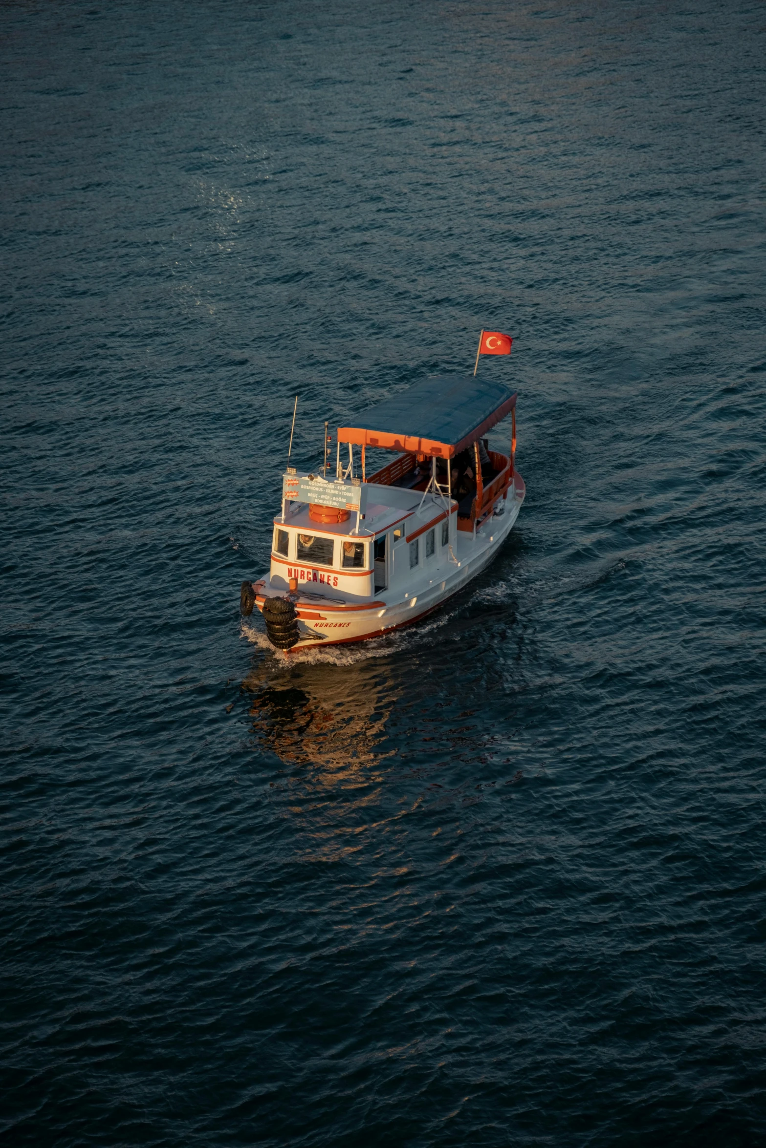 a large boat with lots of passengers moving in the water