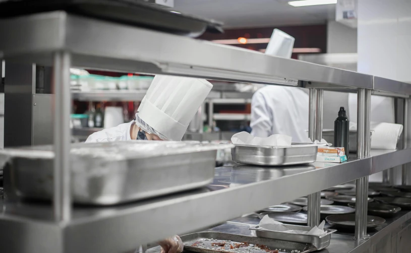 the chefs are working in a commercial kitchen