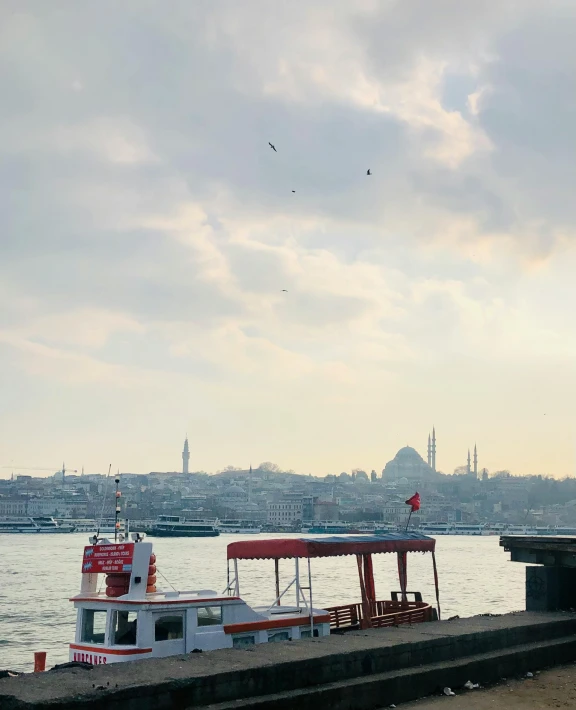 boats sit docked on the water in a city