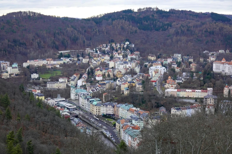 a bird's - eye view of the city with a hillside in the background