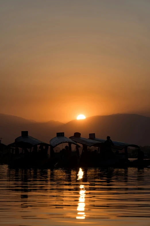 two boats sit docked in front of the sun