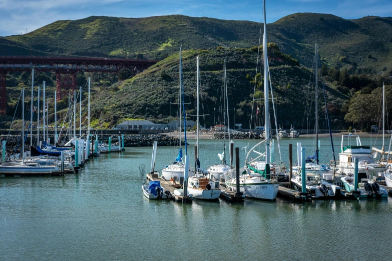 a group of boats sitting docked next to a mountain