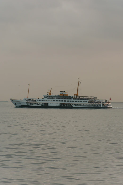 a boat sits on the water and looks like a ferry