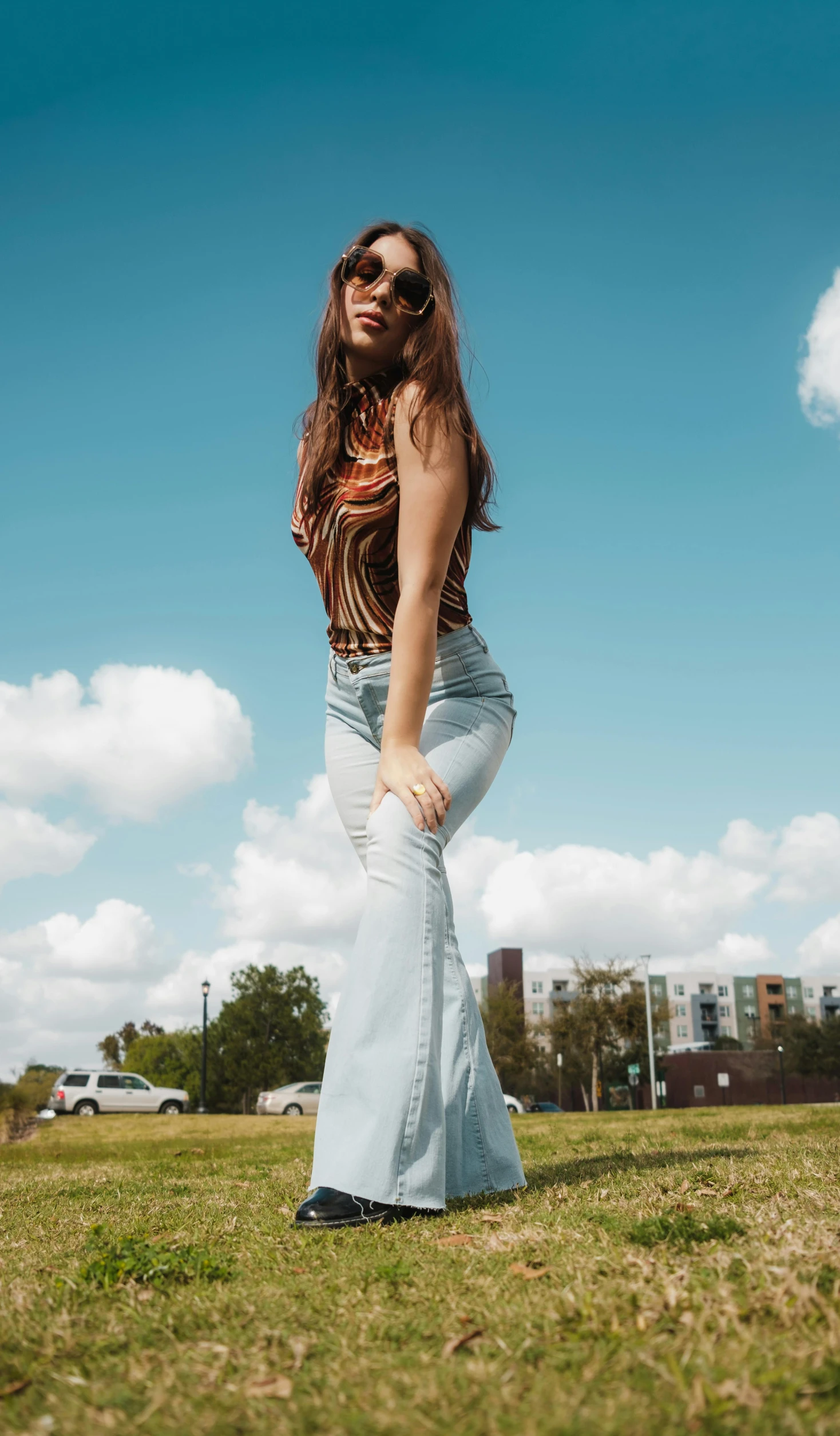 a woman posing for the camera on grass