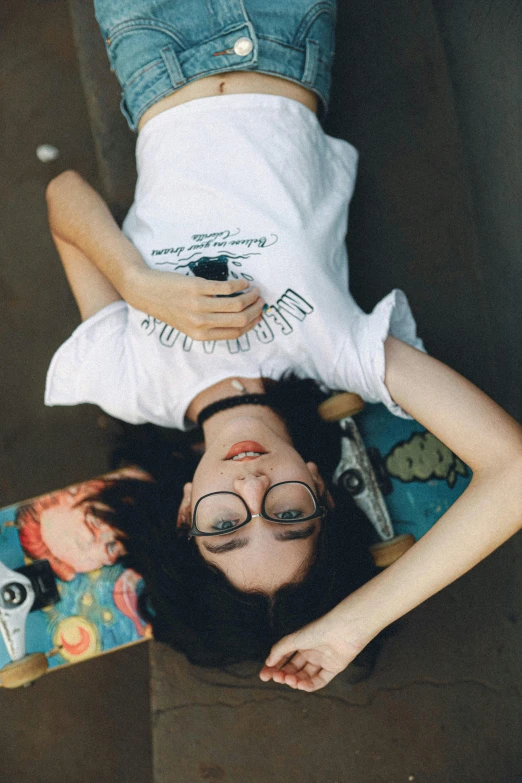 two people laying on the ground and looking down