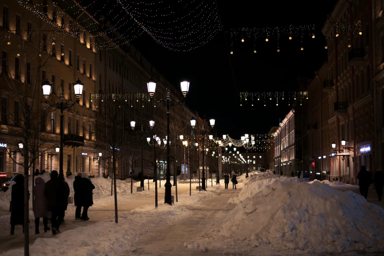 a snowy city street with light colored buildings