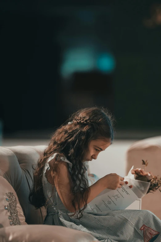 a girl is reading and eating a book