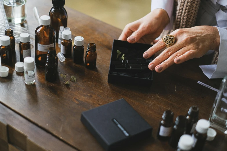 a person holding an open wallet on top of a wooden table